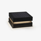 Clérachic square post light on a plain white backdrop, a dark solar-panel lid above a glowing warm band.