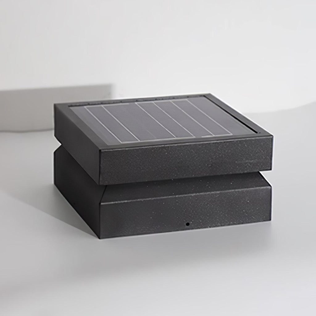 Clérachic square post light unlit on a pale grey surface, showing the ridged solar panel and darker base.