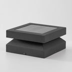 Clérachic post light on a pale grey backdrop, unlit, with a solar panel lid and a tapered base.