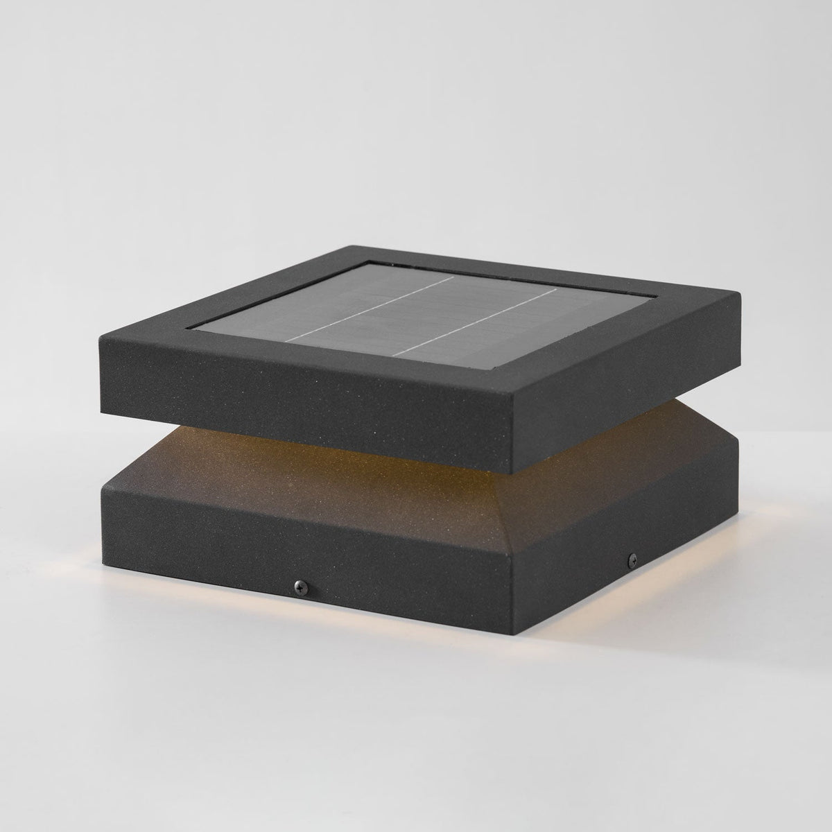 Clérachic post light lit on a pale grey backdrop, a faint warm glow under the lid and along the floor.