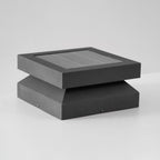 Clérachic post light seen from slightly above on pale grey, the solar panel and ridged base in view.