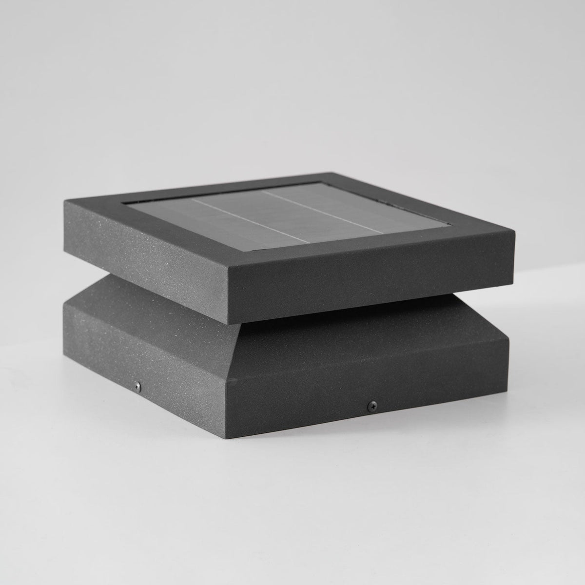 Clérachic post light seen from slightly above on pale grey, the solar panel and ridged base in view.