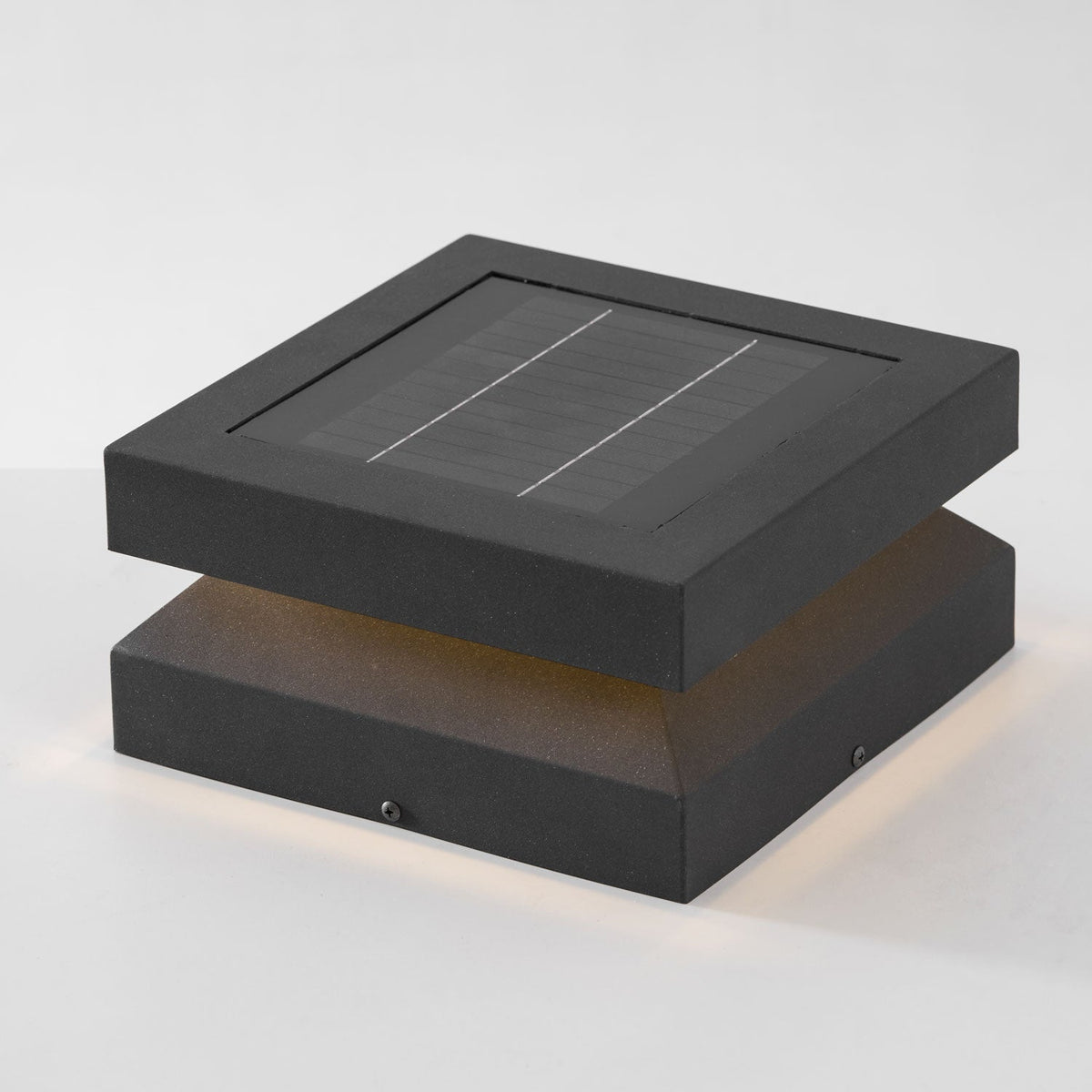 Three-quarter view of a lit Clérachic post light, its solar panel showing two thin dividing lines.