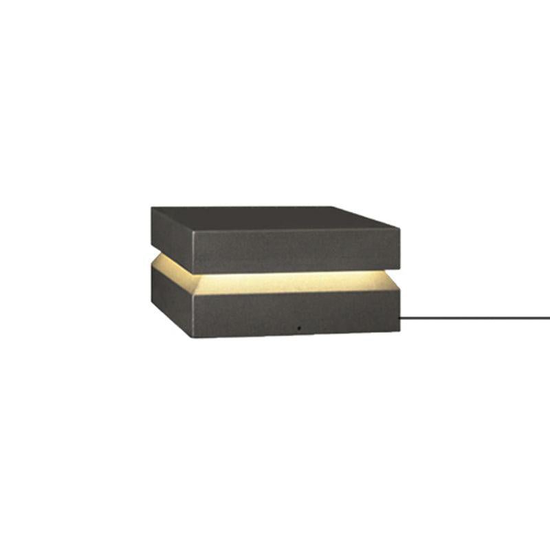 Smaller dark grey Clérachic post light on white, with its power cable leaving the right side of the base.