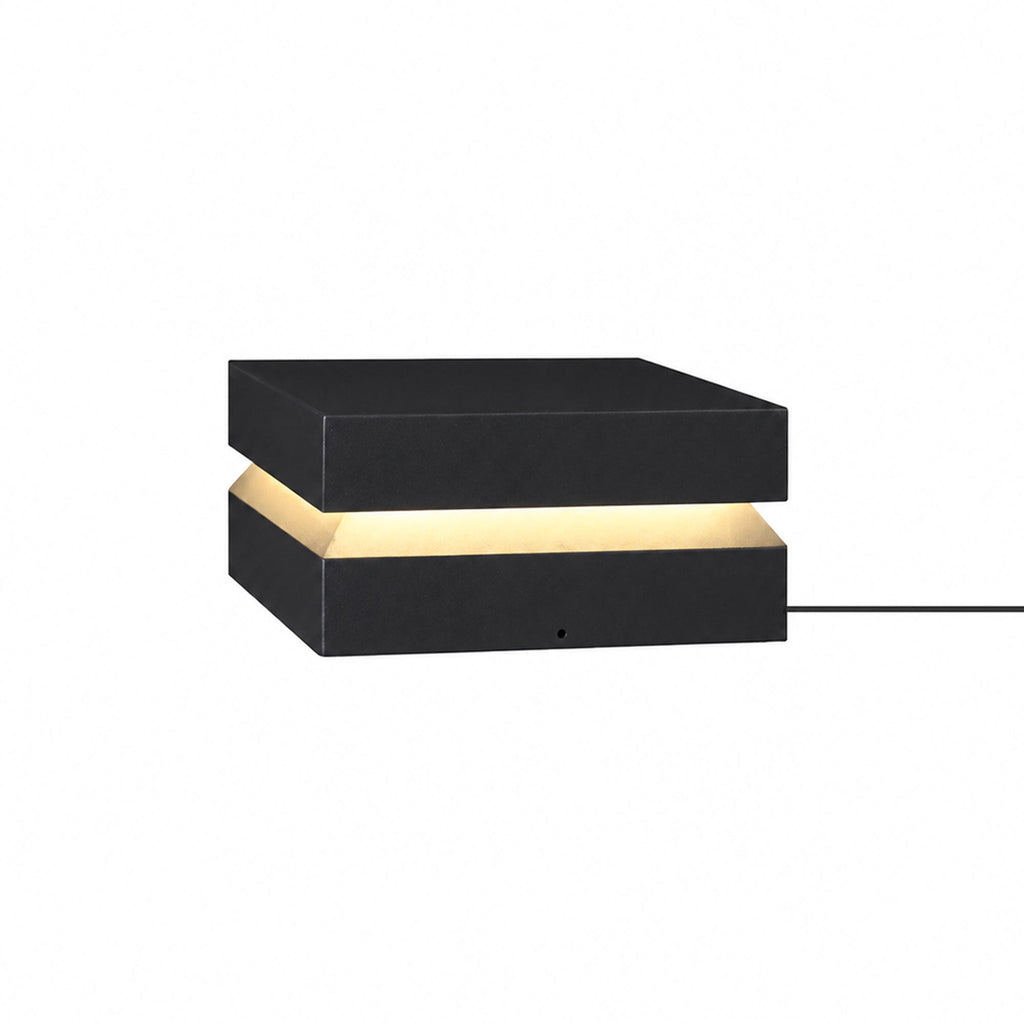 Larger black Clérachic post light on white, with its cable running out to the right.