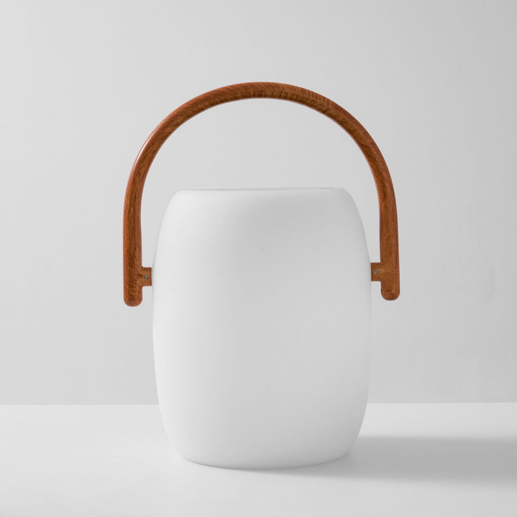 Front view of the white Clérachic lantern with an arched wood-grain handle, shown unlit on a light grey backdrop.