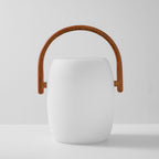 Front view of the white Clérachic lantern with an arched wood-grain handle, shown unlit on a light grey backdrop.