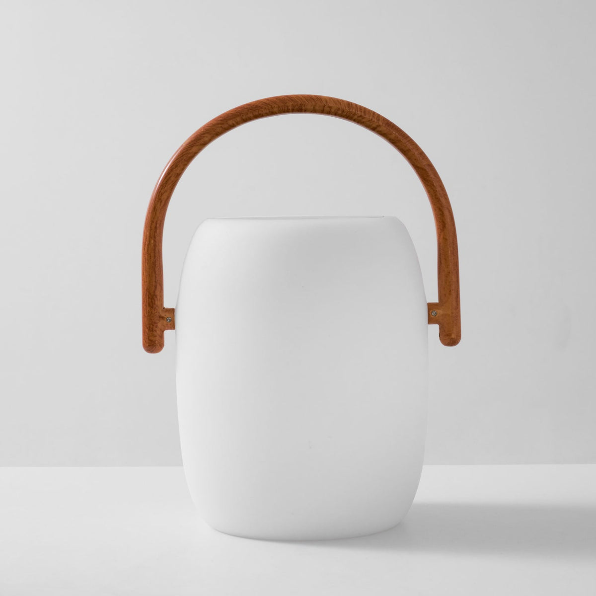 Front view of the white Clérachic lantern with an arched wood-grain handle, shown unlit on a light grey backdrop.