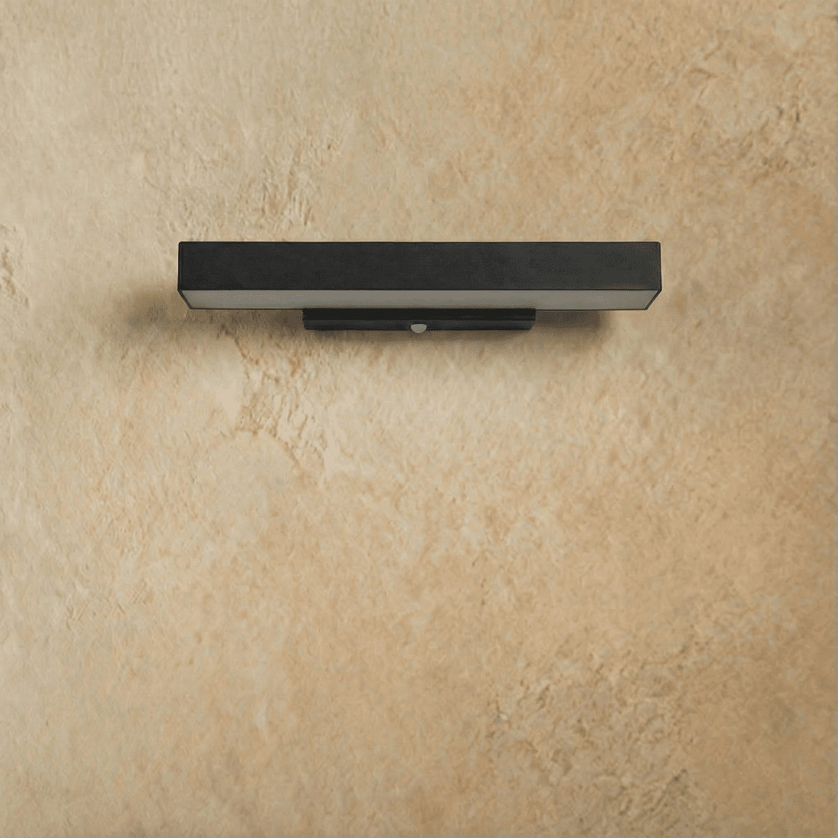 Clérachic mid-length black aluminium bar wall light switched off, showing its opal diffuser and bracket on a plaster wall.