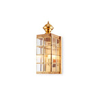 Small Clérachic brass lantern wall light on a white backdrop, with its etched brass band and glass panes in full view.