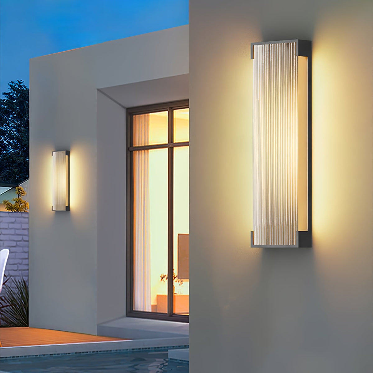 A tall Clérachic wall light in the foreground and a smaller one behind, on a white house beside a lit window.