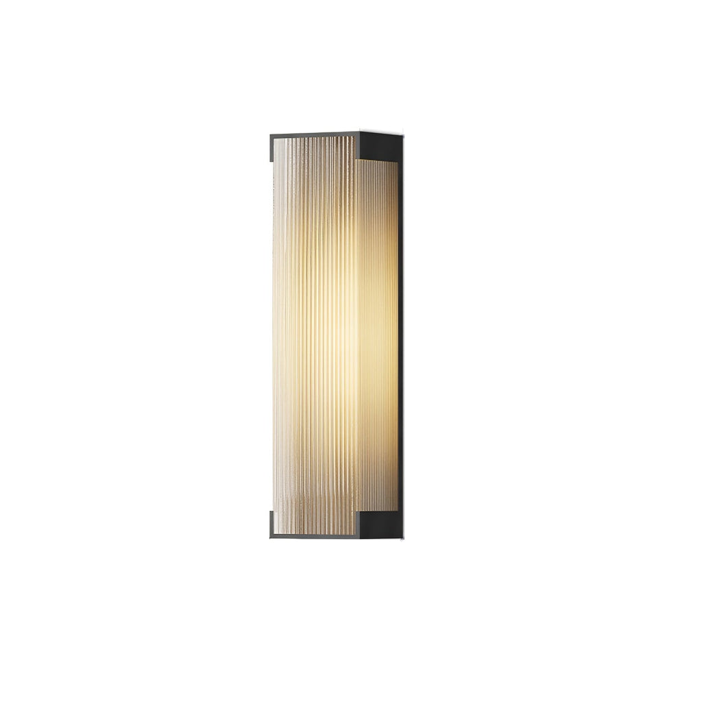 Side-angle view of a tall Clérachic wall light with a ribbed diffuser, lit softly on a white background.