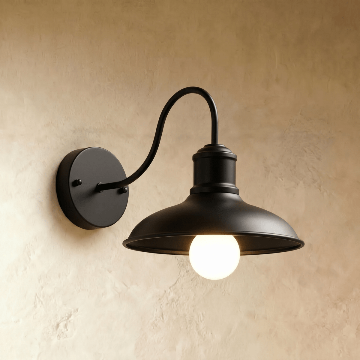 Clérachic matte black gooseneck wall lamp with a wide downward dome shade and a glowing opal bulb on plaster