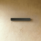 Clérachic slim black rectangular wall light, switched off, with its pale diffuser strip along the underside, on limewash.