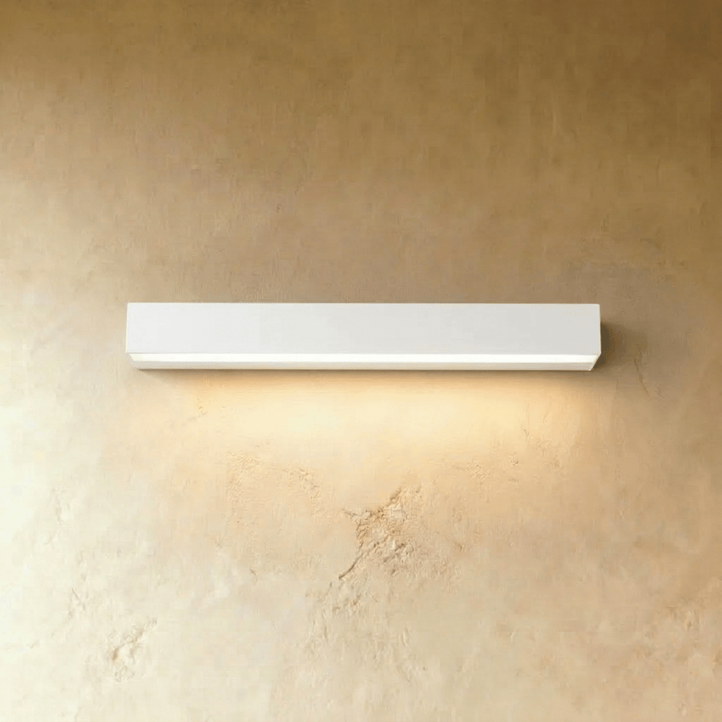 Clérachic longest slim white wall light in this set, washing a warm band of light down a limewashed wall.