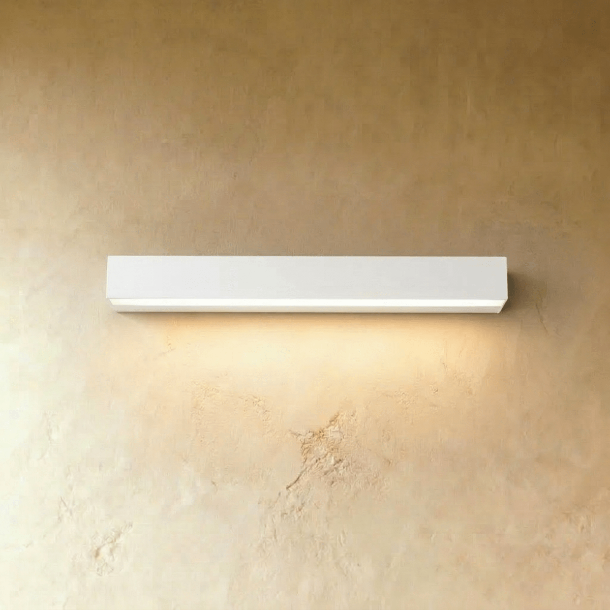 Clérachic longest slim white wall light in this set, washing a warm band of light down a limewashed wall.