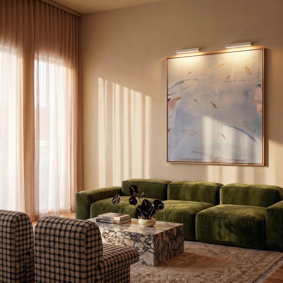 Clérachic two slim white wall lights above a large framed painting, in a living room with a green velvet sofa.