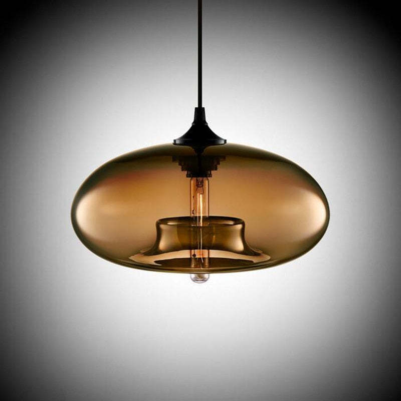 Studio view of the Clérachic oval blown glass pendant light in brown glass, the inner collar and filament bulb showing through.