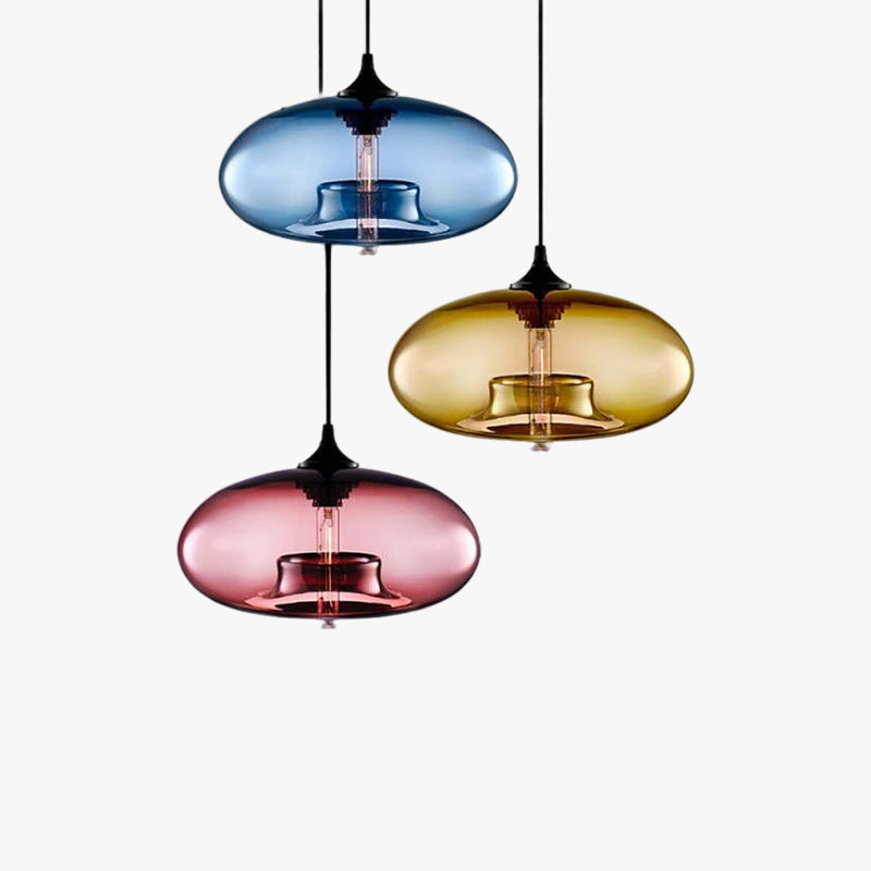 Three Clérachic oval blown glass pendant lights clustered at staggered drops in blue, amber and pink glass on white.