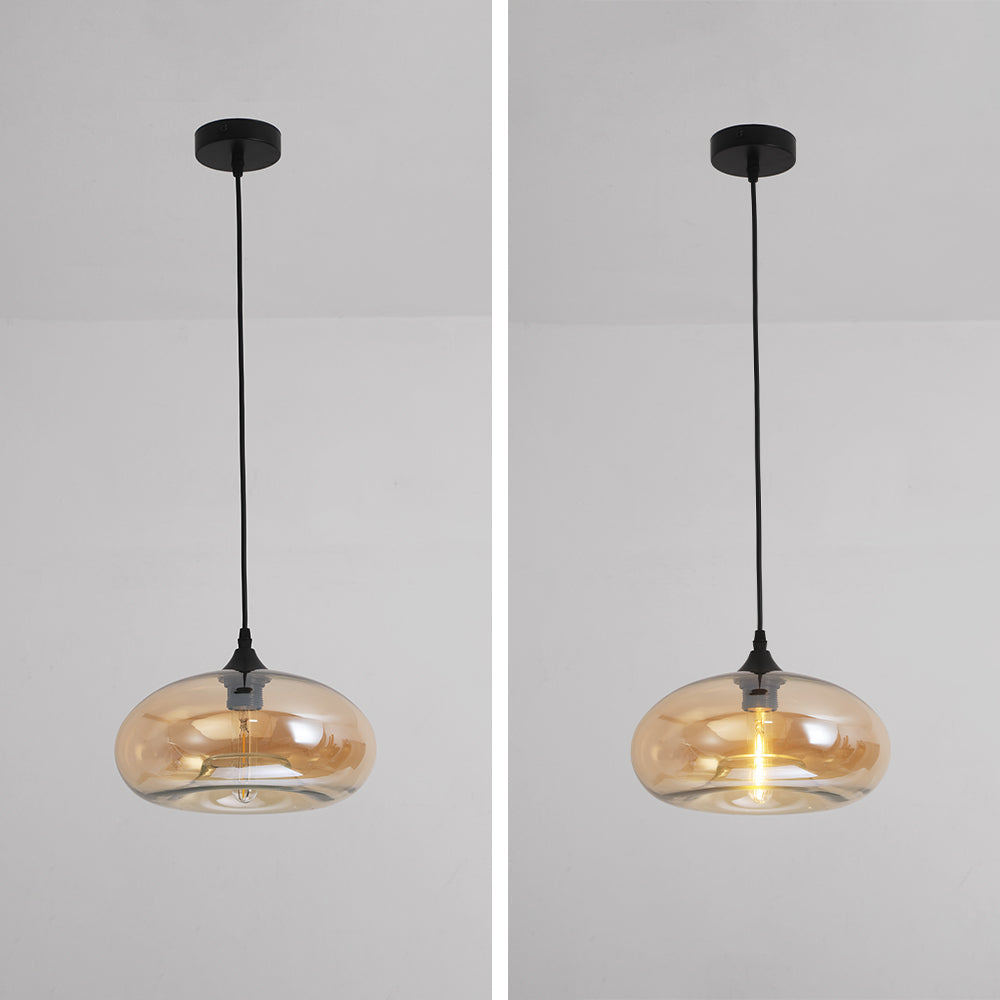 Side-by-side of the Clérachic oval pendant light in amber glass, unlit on the left and lit on the right at full cord drop.