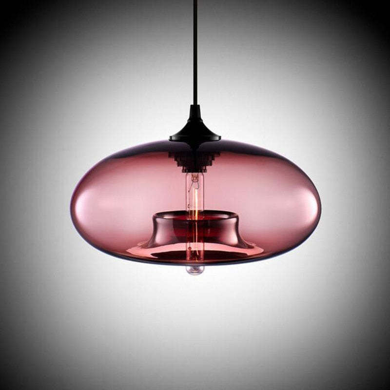 Clérachic oval blown glass pendant light in dusty rose glass, lit filament reflected across the polished shade.