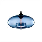 Blue glass Clérachic oval pendant light photographed on plain white, cord and black socket cup visible above the shade.