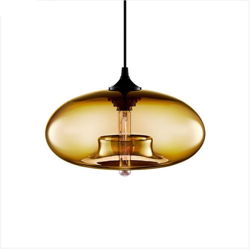 Deep amber Clérachic oval blown glass pendant light on white, the gold-toned shade catching light along its curve.