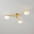 Brass three-head Clérachic Oval Opal Glass Ceiling Light unlit, its blade arms fanning across a soft grey ceiling.