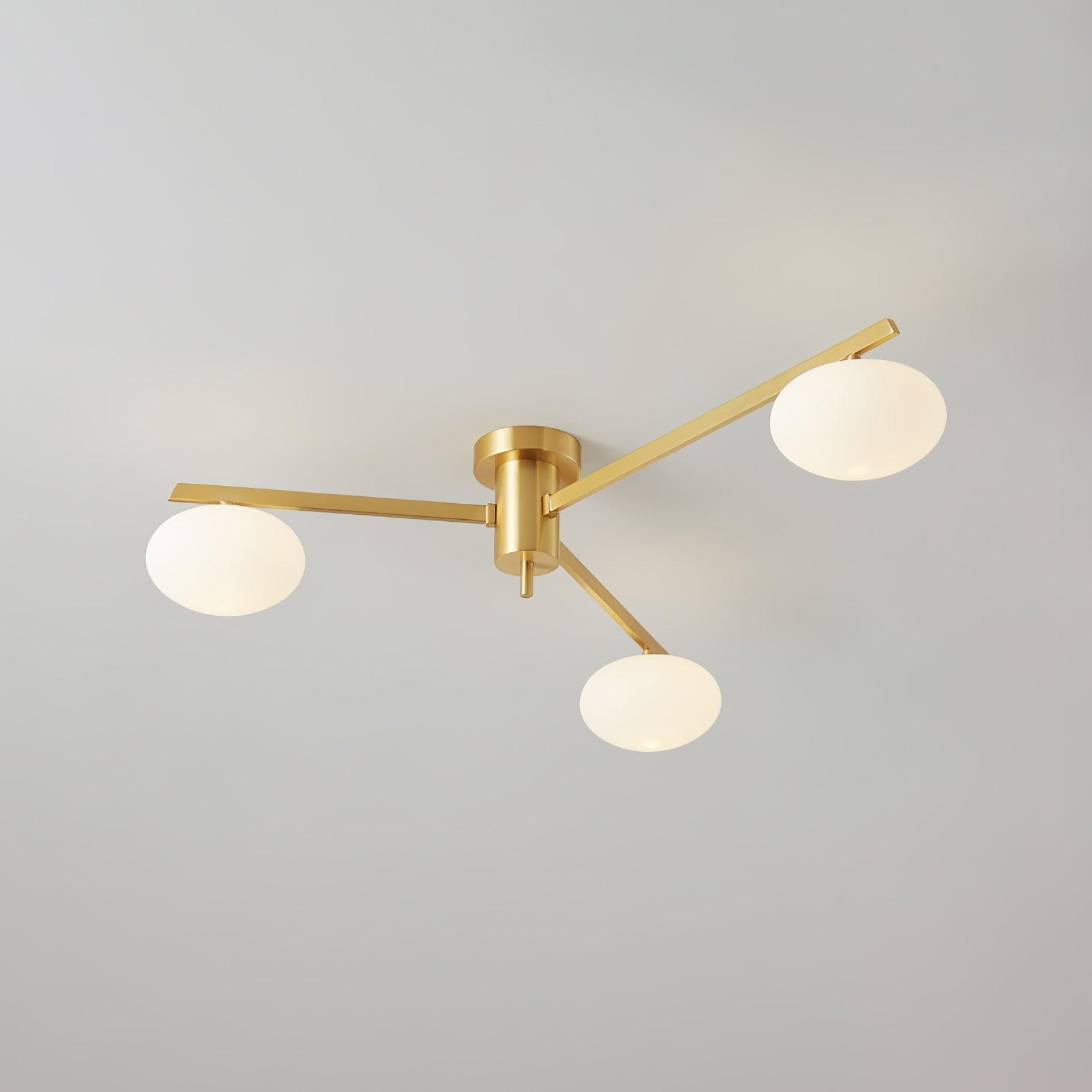 Brass three-head Clérachic Oval Opal Glass Ceiling Light unlit, its blade arms fanning across a soft grey ceiling.