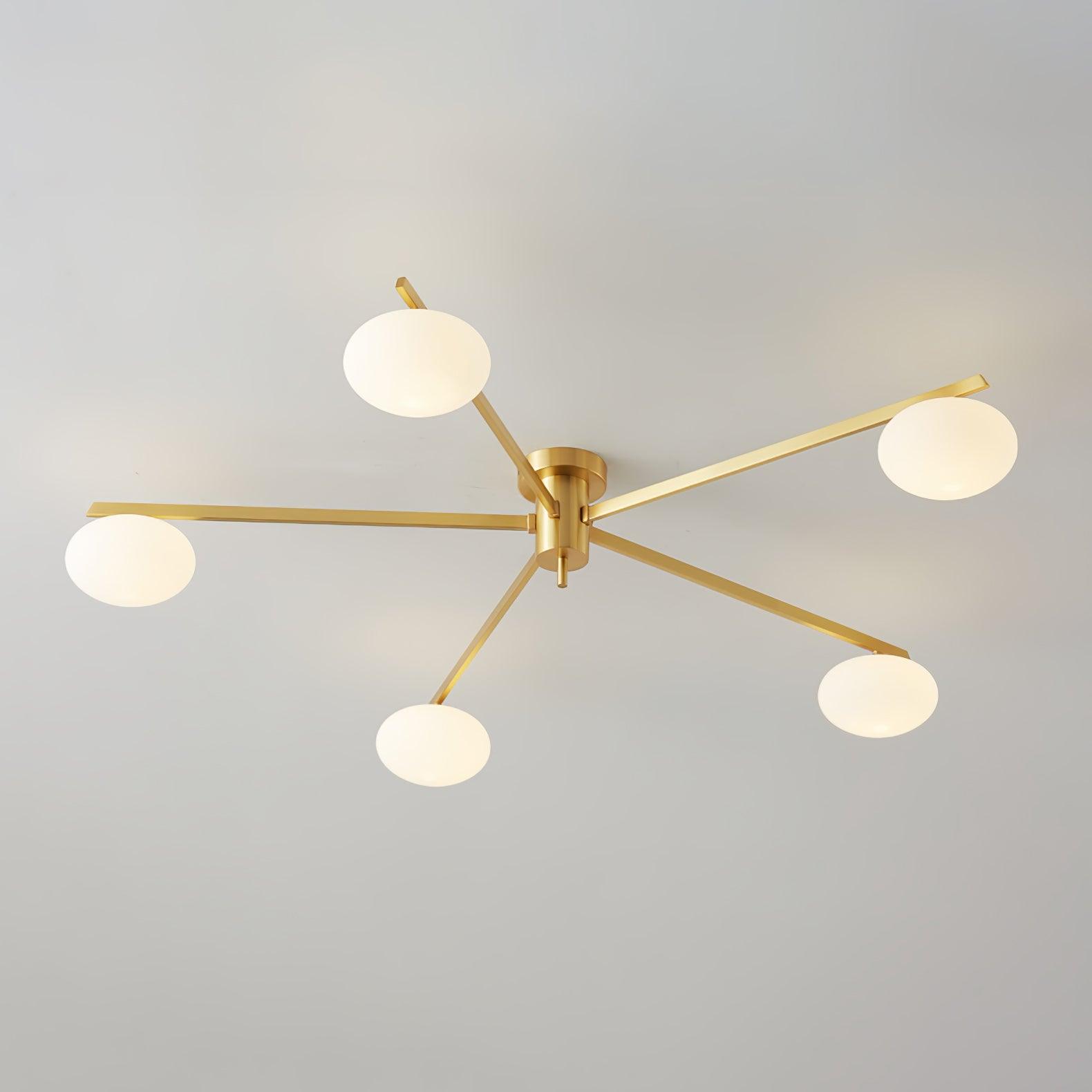 Five-arm brass Clérachic Oval Opal Glass Ceiling Light seen unlit, each oval shade chalk-white against grey plaster.