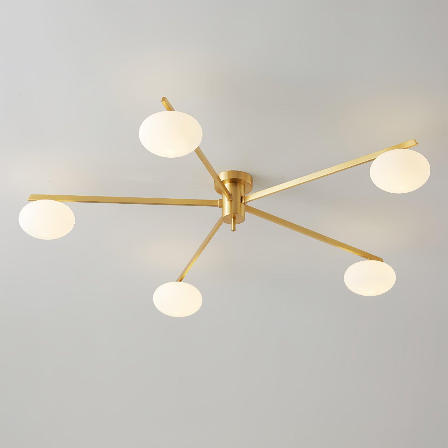 Clérachic Oval Opal Glass Ceiling Light in brass with five shades, arms set at even angles on a grey ceiling.