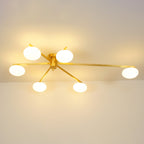Clérachic Oval Opal Glass Ceiling Light switched on in brass, six shades lighting a room from the ceiling line.