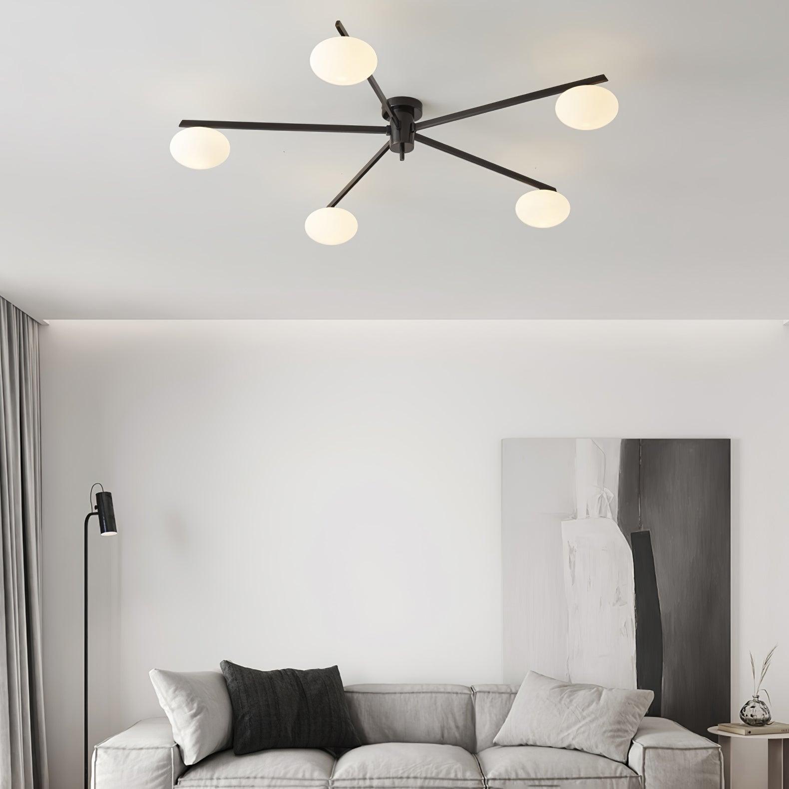 Clérachic Oval Opal Glass Ceiling Light in black above a grey sofa and floor lamp in a calm living room.