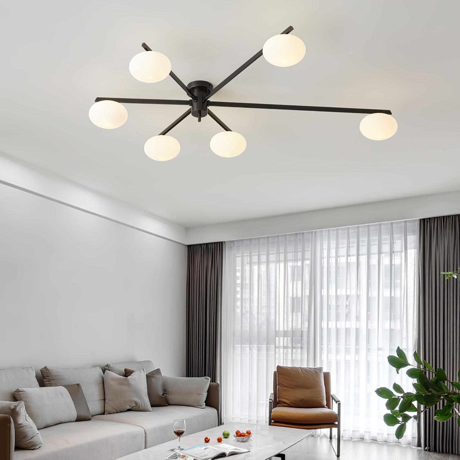 Clérachic Oval Opal Glass Ceiling Light in black spanning a living room ceiling above a sofa and tan armchair.