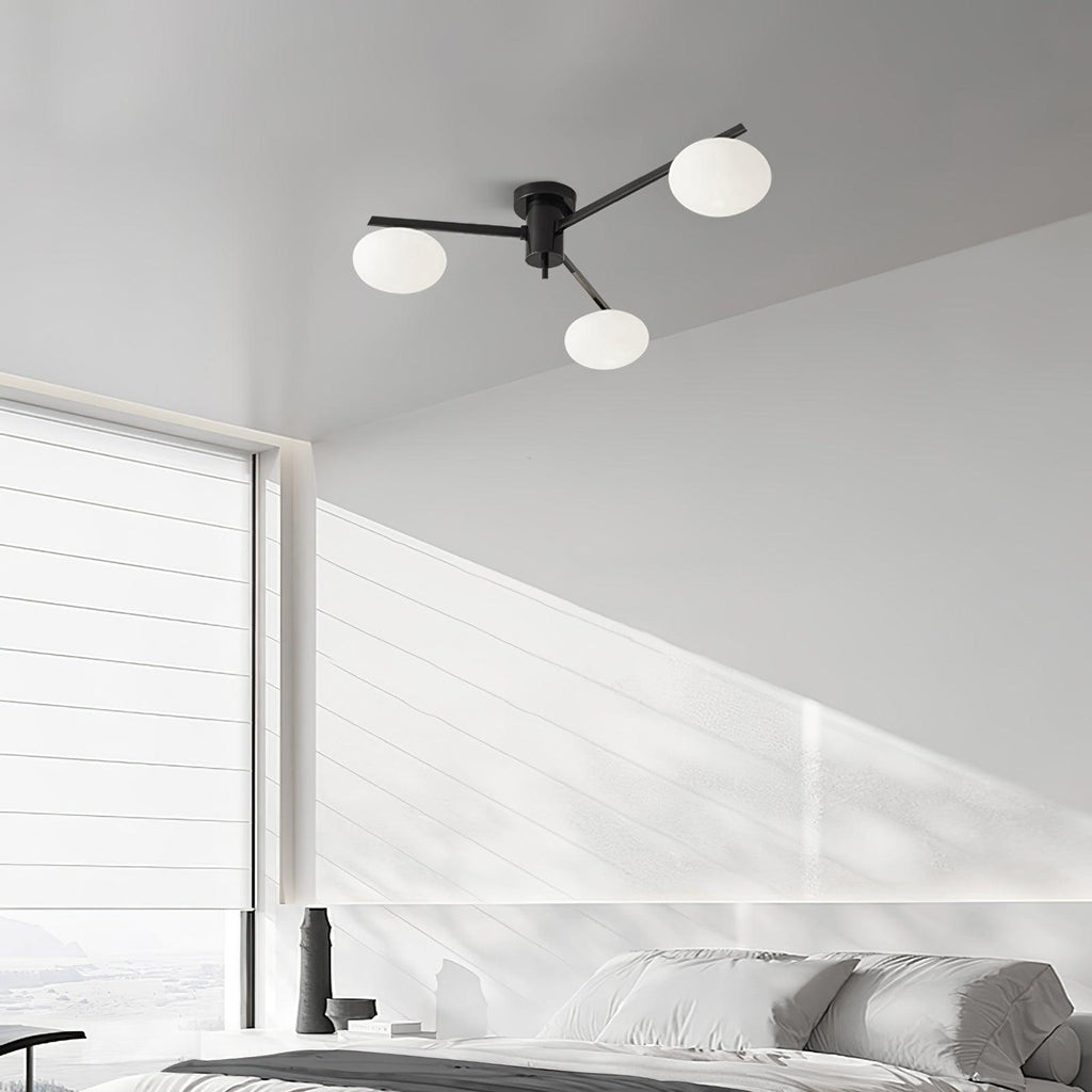 Clérachic Oval Opal Glass Ceiling Light in black, three shades over a white panelled bedroom with morning light.