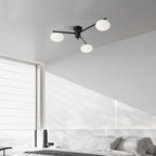 Clérachic Oval Opal Glass Ceiling Light in black, three shades over a white panelled bedroom with morning light.