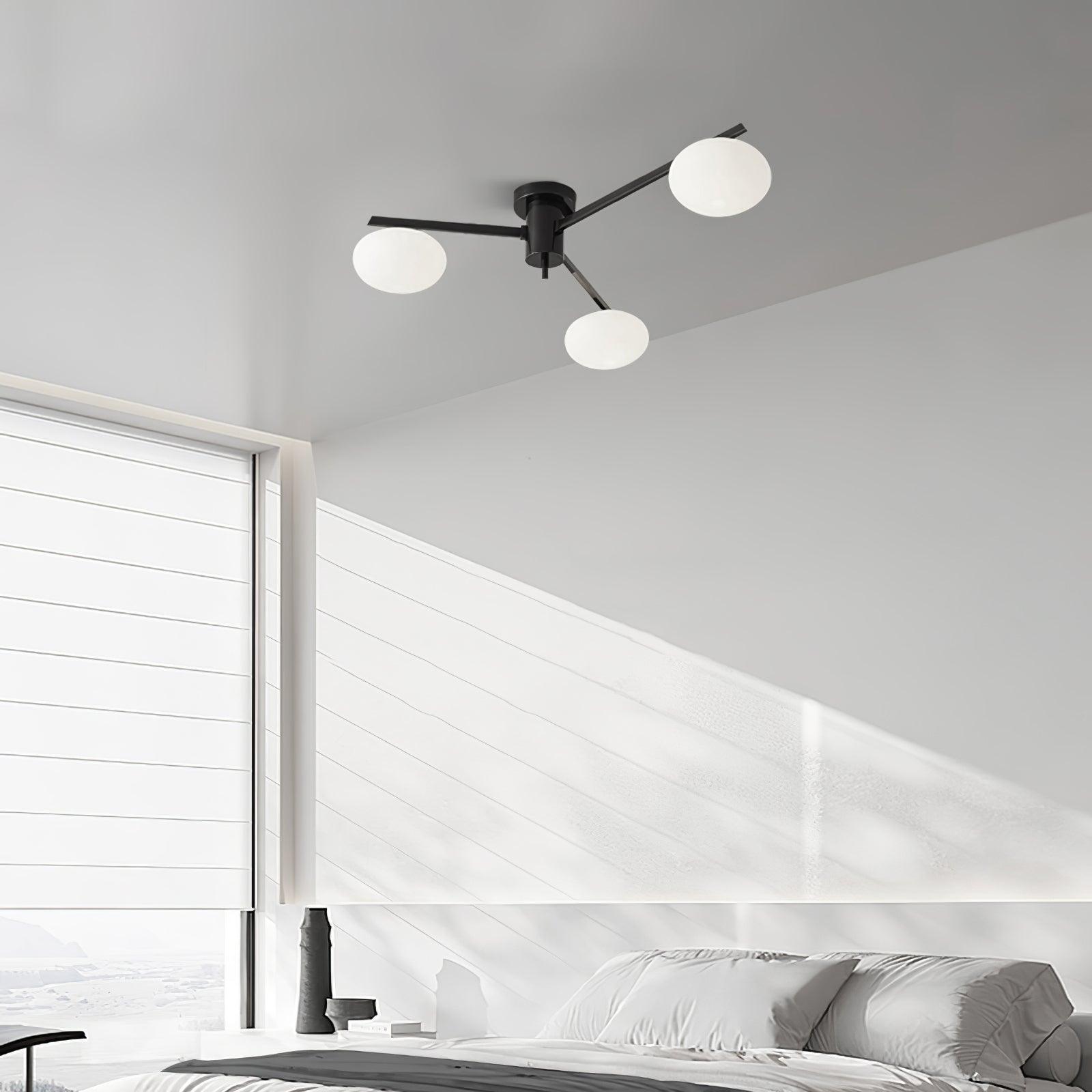 Clérachic Oval Opal Glass Ceiling Light in black, three shades over a white panelled bedroom with morning light.