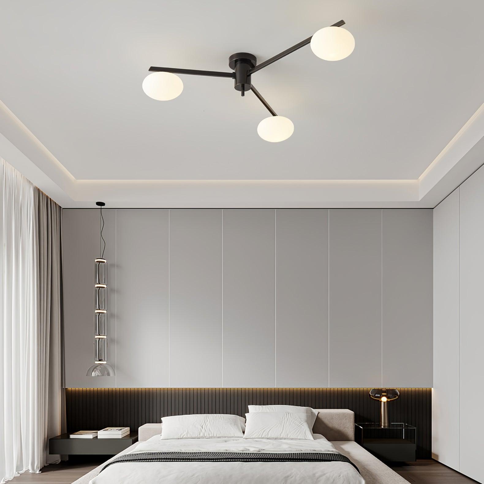 Clérachic Oval Opal Glass Ceiling Light in black above a bed, set against a panelled grey wall and coved ceiling.