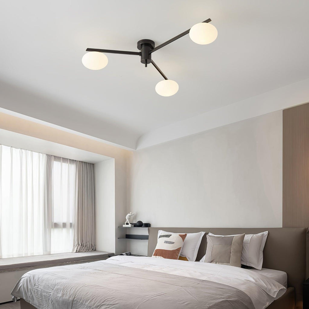 Clérachic Oval Opal Glass Ceiling Light in black over a bedroom with a window seat and layered linen bedding.