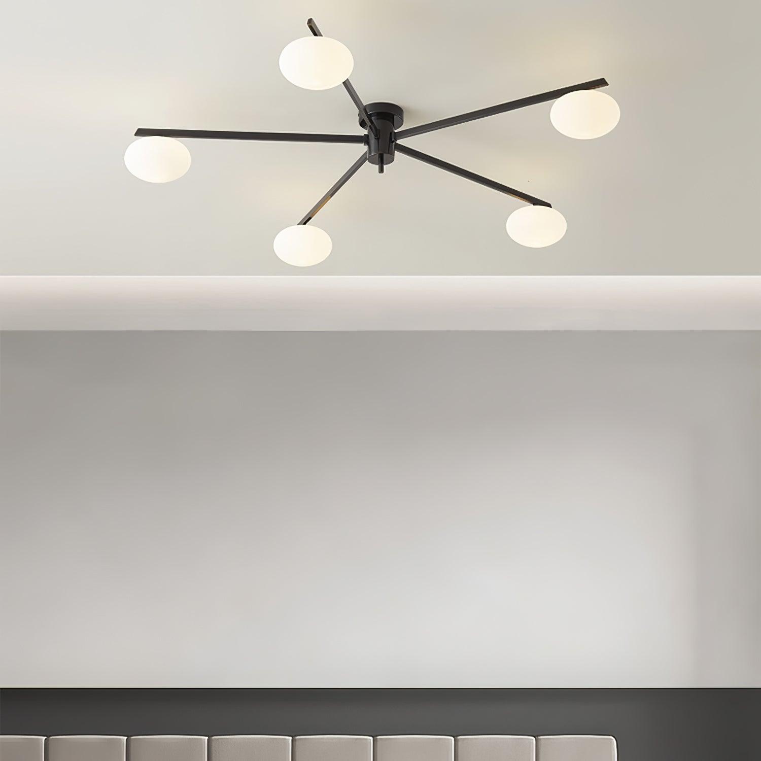 Clérachic Oval Opal Glass Ceiling Light in black mounted flush to a coved ceiling above a panelled headboard.