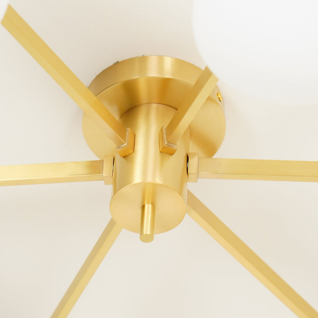 Canopy close-up of the Clérachic Oval Opal Glass Ceiling Light in brass, six flat arms slotting into the base.