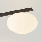Single opal oval shade on the black blade arm of the Clérachic Oval Opal Glass Ceiling Light, seen up close.