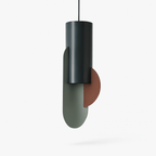 Clérachic slim cylindrical pendant in deep teal metal with a sage-green oval disc and a terracotta half-disc, on a white ground.