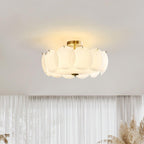 The Clérachic overlapping glass disc semi-flush ceiling light lit in a room with sheer curtains and dried pampas grass.