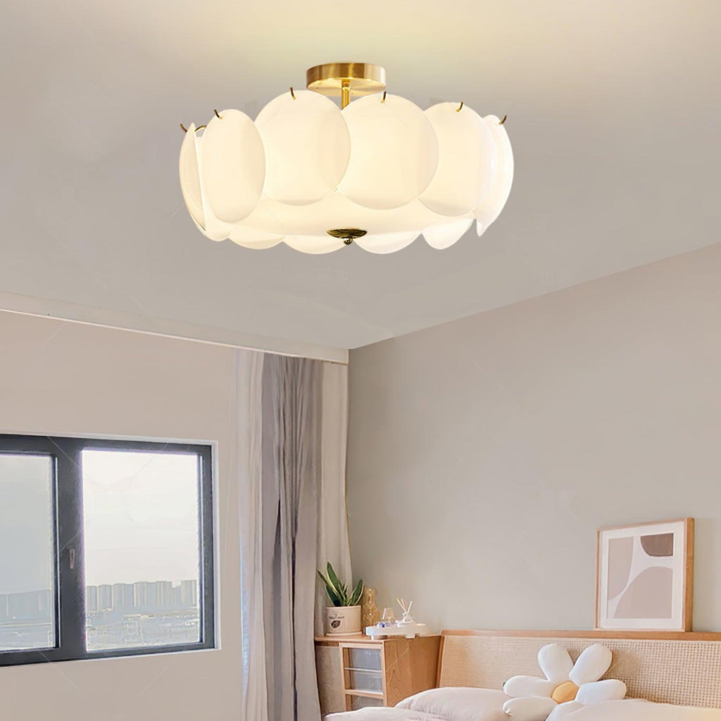 The Clérachic overlapping glass disc semi-flush ceiling light lit above a corner with framed art prints and crown molding.