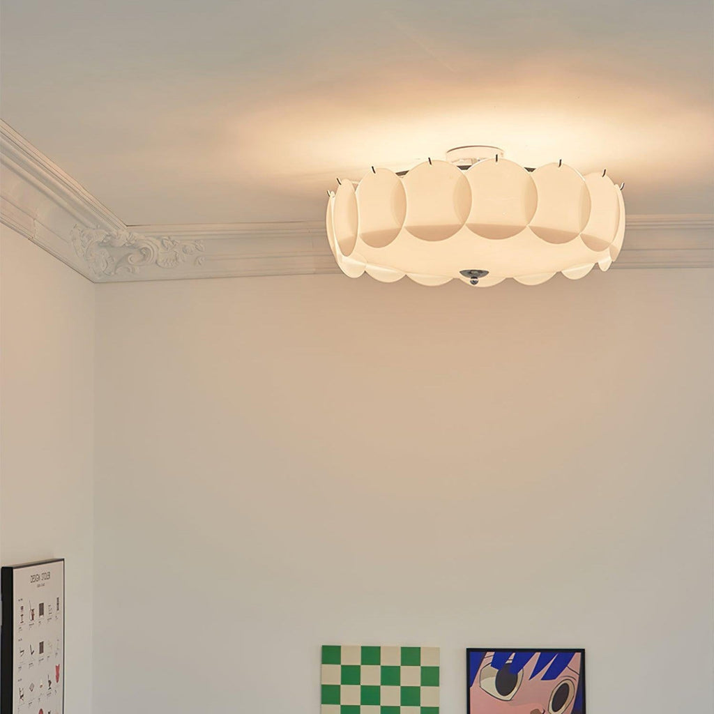 A close corner view of the Clérachic overlapping glass disc semi-flush ceiling light lit beside a doorway.