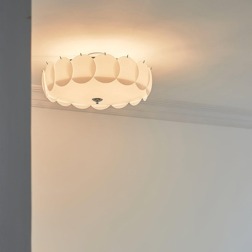 The Clérachic overlapping glass disc semi-flush ceiling light lit close to a doorway and patterned crown molding.