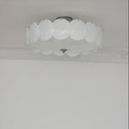 Close-up of the unlit Clérachic overlapping glass disc semi-flush ceiling light with its chrome ceiling canopy.