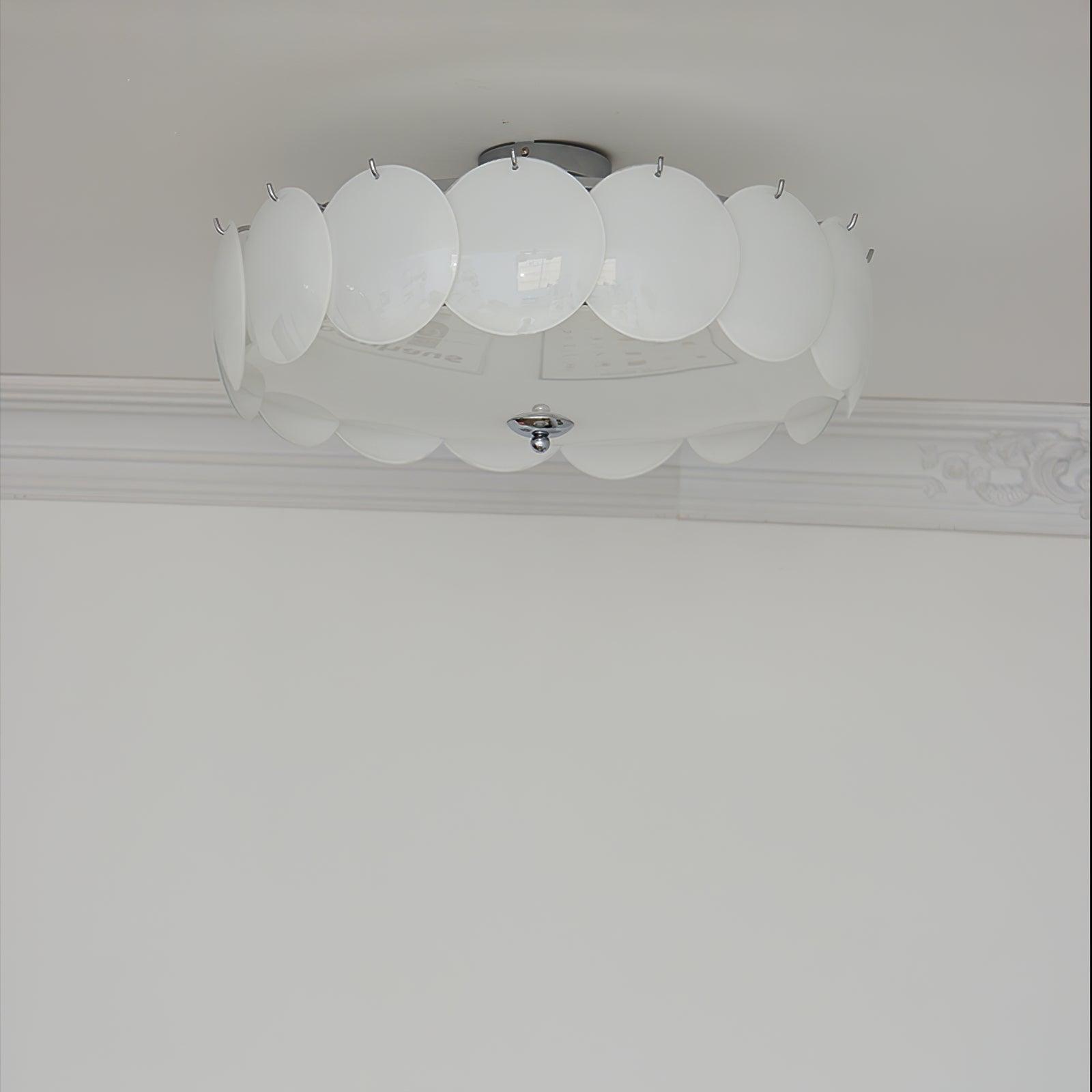 Close-up of the unlit Clérachic overlapping glass disc semi-flush ceiling light with its chrome ceiling canopy.