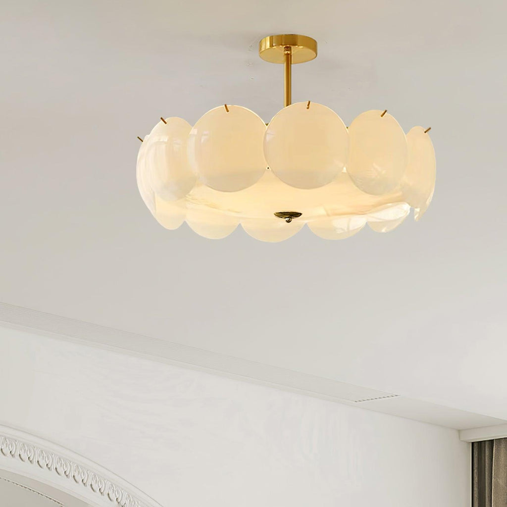 The Clérachic overlapping glass disc semi-flush ceiling light lit in a bedroom corner with arched crown molding.